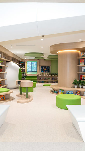 LIBRARY, KINDERGARTEN DESIGN

Kindergarten library interior designed by MAD Studio, showcasing innovative architecture and design. The library features curved wooden bookshelves, vibrant green seating areas, and minimalist plant decor, creating an inviting and tranquil environment for readers. Ideal for educational and community spaces. 