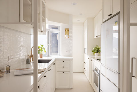 Sleek modern kitchen design by MAD Studio featuring minimalist white cabinetry, elegant gold fixtures, and abundant natural light. Perfect inspiration for luxury home interiors, contemporary kitchen decor, and innovative space-saving solutions. Discover stylish interior design ideas with high-quality finishes at MAD Studio.