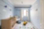 Modern children's room design in Hong Kong with a pastel blue color palette, featuring a sleek wooden crib, plush armchair, and playful aviation-themed wall art. The room is styled with a fun, colorful carpet and a small yellow car for a cozy and chic atmosphere. Perfect for interior design inspiration and home decor trends, showcasing the latest in kids' room ideas in urban settings.